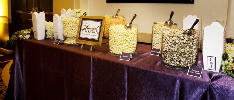 Popcorn bar setup at a wedding in purple theme